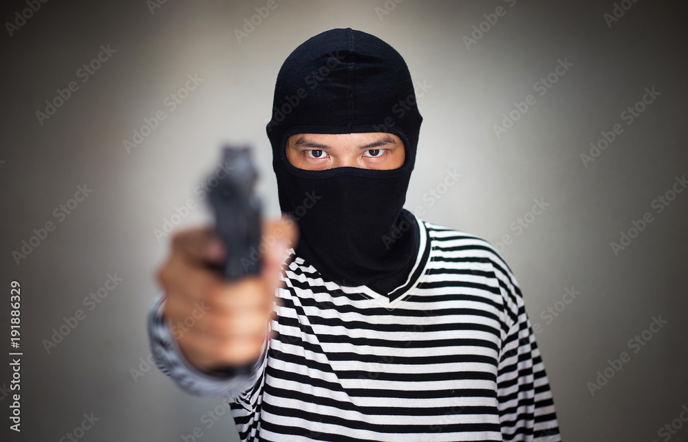 terrorist ware mask and hold pistol, gun, in hand terrorist ware mask and hold pistol, gun, in hand