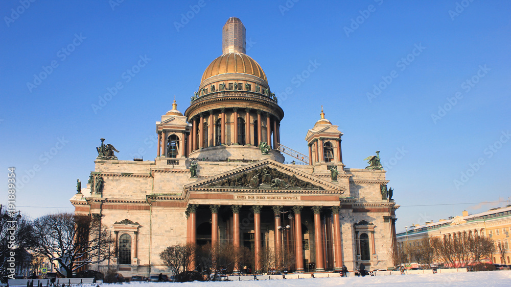 Saint Isaac's Cathedral and Museum Building in St. Petersburg, Russia. Russian Classical Old Religious Symbol Architecture on Sunny Cold Winter Snowy Day against Blue Sky Background Copy Space.