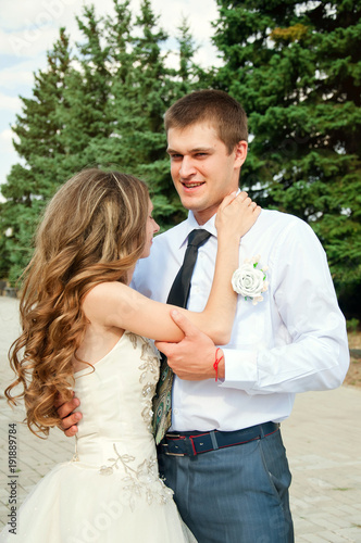 Wedding Day.  Beautiful Bride in the Arms of the Groom. Happy Fun Coulple photo