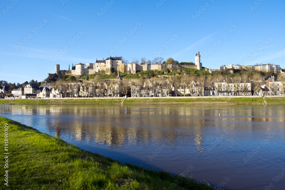 Chinon town with its chateau on the hill above in spring afternoon sunshine on the banks of the River Vienne, Indre-et-Loire, France