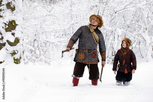 Portrait strong viking warrior winter woods battle scandinavian traditional clothing lumberjack chain mail leather spear deep forest thrones kids son