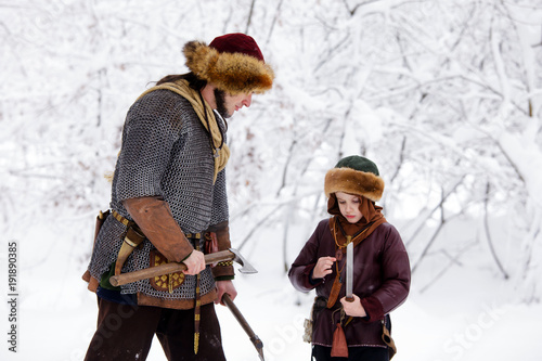 Portrait strong viking warrior winter woods battle scandinavian traditional clothing lumberjack chain mail leather spear deep forest thrones kids son