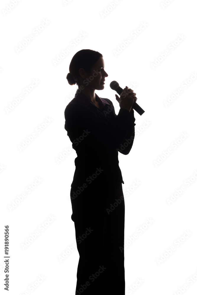 Young woman singing into the microphone Young woman singing into the microphone