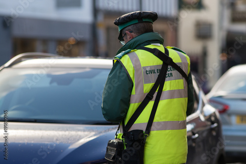 Wallpaper Mural traffic warden or civil enforcement officer issuing parking ticket fine in UK