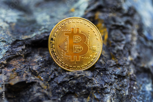  Golden bitcoin as main digital currency worldwide presented on the stone.