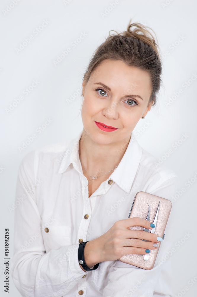 Closeup Portrait of Female Visagist with Eyebrow Tweezerson and Charming Smile on White Background. Closeup Portrait of Female Visagist with Eyebrow Tweezerson and Charming Smile on White Background.