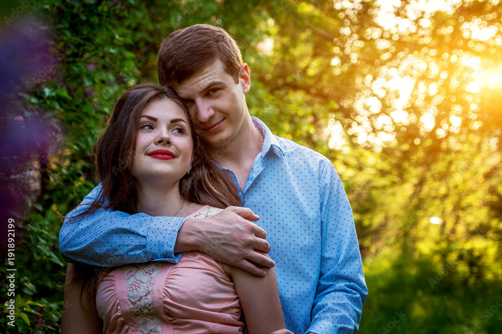 Fototapeta premium Portrait of young love couple in the garden