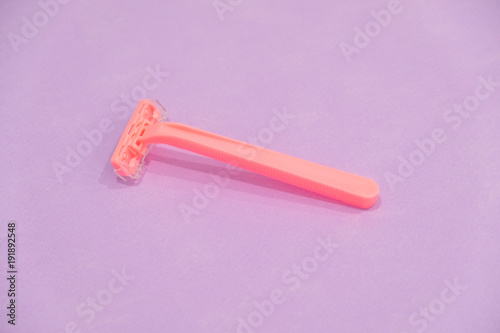 pink women's disposable razors . Hygiene skin body care concept. Hair removal. Focus on razor.
