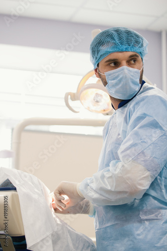 Doctor surgeon during stomatology surgery in dentistry room