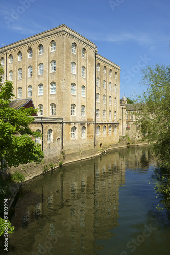 Picturesque old industrial architecture by the River Avon in spring sunshine, Bradford on Avon, Wiltshire, UK