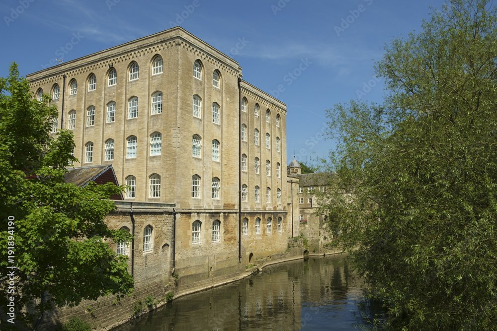 Picturesque old industrial architecture by the River Avon in spring sunshine, Bradford on Avon, Wiltshire, UK