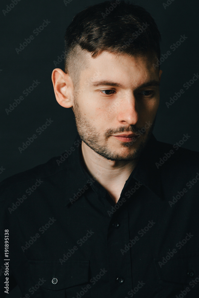 Man in headphones and black shirt on a black background Man in headphones and black shirt on a black background