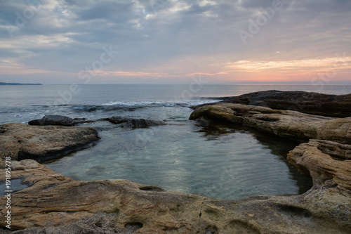 Sea sunrise at the Black Sea coast near Ravda, Bulgaria. Rocky sunrise. photo