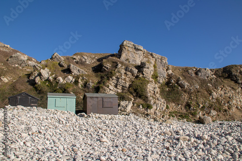 Beach Huts by a Cliff Face