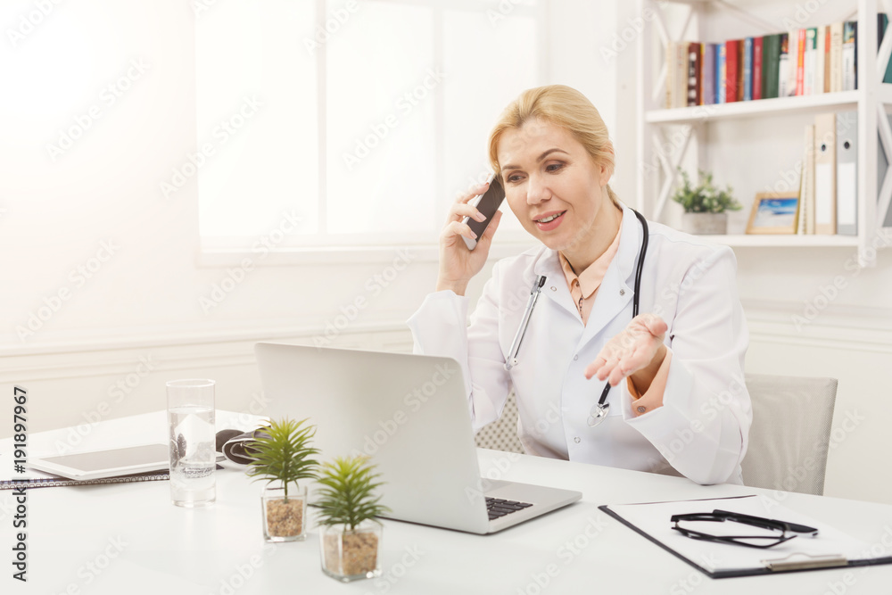 Emotional doctor talking on the phone with her patient Emotional doctor talking on the phone with her patient