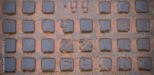wet rusty sewer hatch. vignette, background, texture