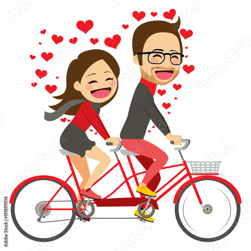 Cute young couple on Valentine day riding on tandem bicycle celebrating love together