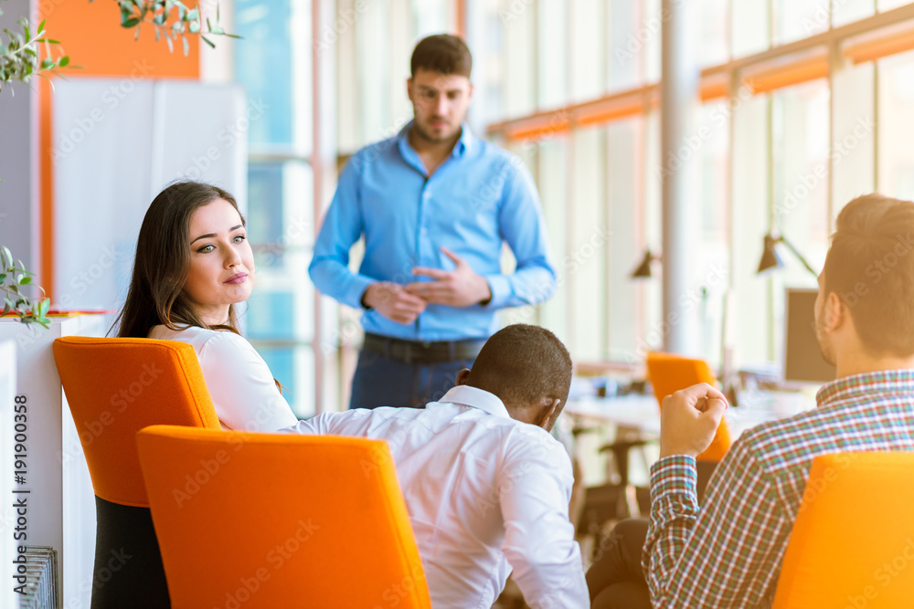 Group of casually dressed businesspeople discussing ideas in the office. Group of casually dressed businesspeople discussing ideas in the office.