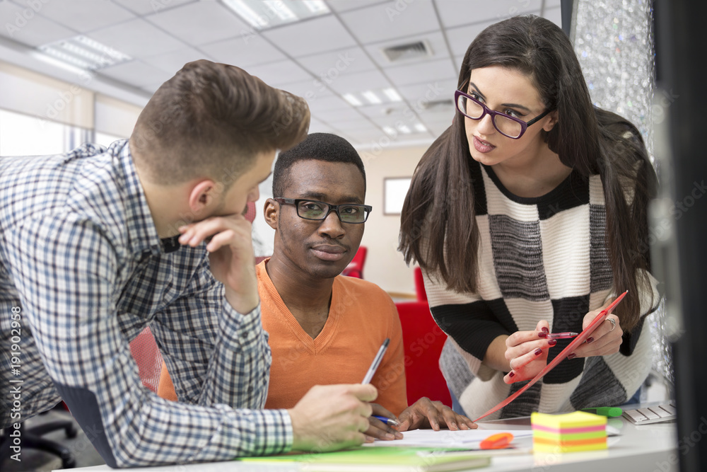 Multiracial contemporary business people working connected with technological devices like tablet and laptop Multiracial contemporary business people working connected with technological devices like tablet and laptop