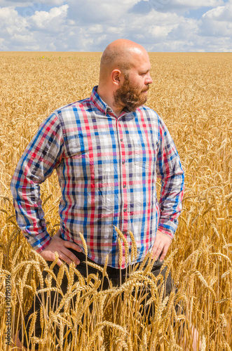 Farmer standing in wheat field