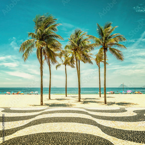 Palms on Copacabana Beach and landmark mosaic in Rio de Janeiro, Brazil. Vintage colors