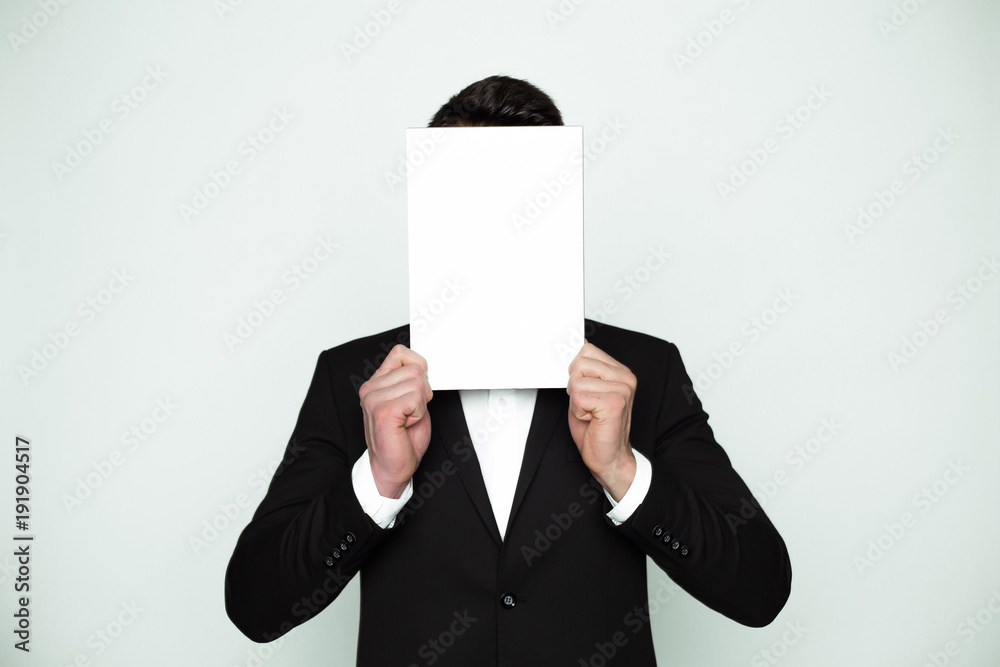 Blank area for inscriptions. A young tall man covers his face with a white board.