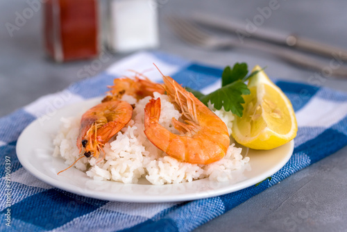 Plate with fried prawns and rice. Seafood.