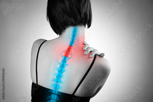 Pain in the spine, woman with backache, injury in the human back and neck