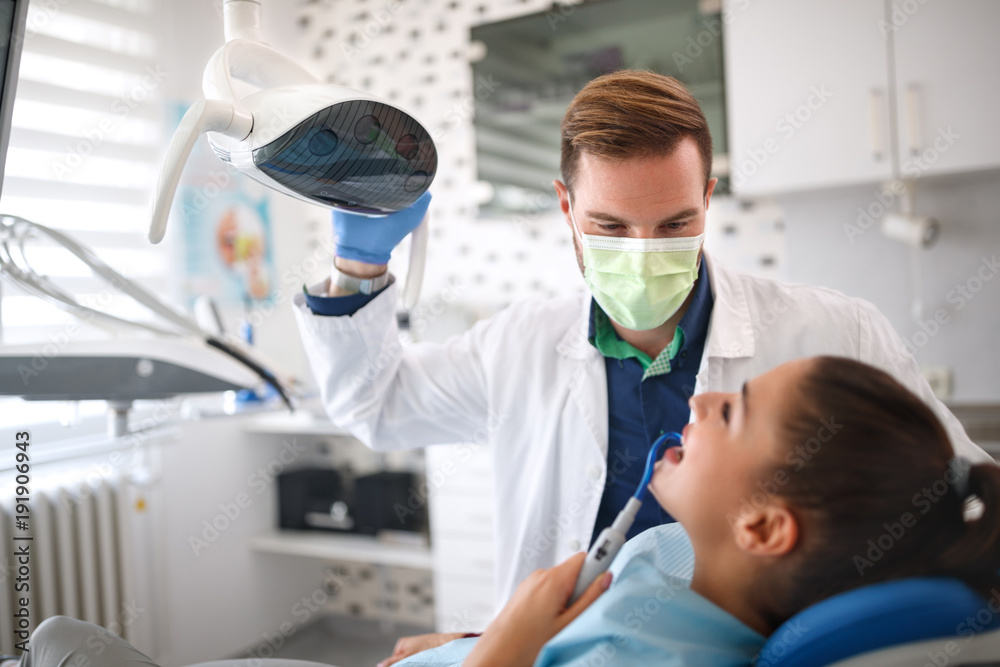 Dentist examining girl on clinic Dentist examining girl on clinic