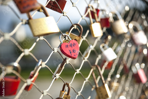 as a promise of love, the lovers close padlocks along the bridges