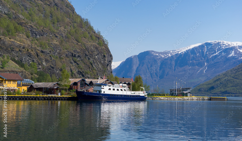 A blue cruise during parking at the harbor in Flam, Norway