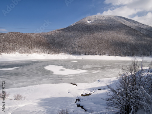 Frozen lake, Passi Lagastrello in the Italian Appennine mountains. photo