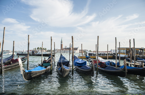 the famous gondolas in Venice moored in the lagoon © Stefania