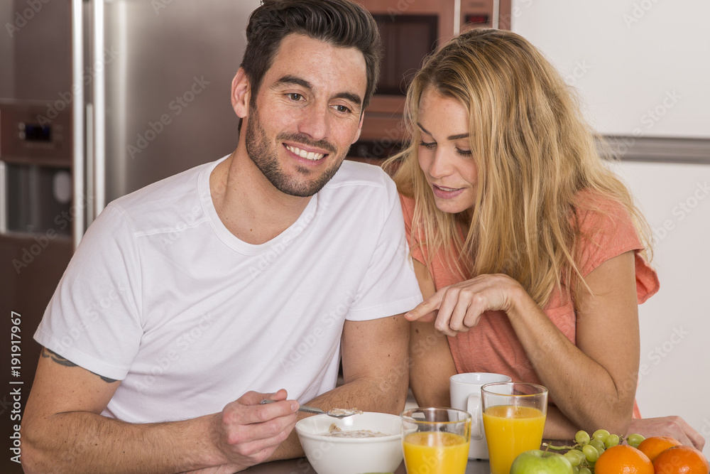 couple having breakfast in home kitchen couple having breakfast in home kitchen