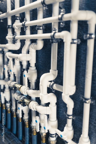 white plastic pipes in boiler room