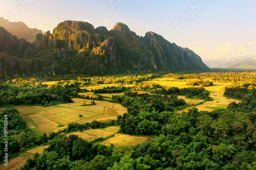 Aerial view of farm fields and rock formations in Vang Vieng, Vientien Province, Laos