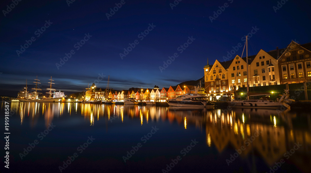 A night long exposure photography of Bergen at harbor  with beautiful water reflection