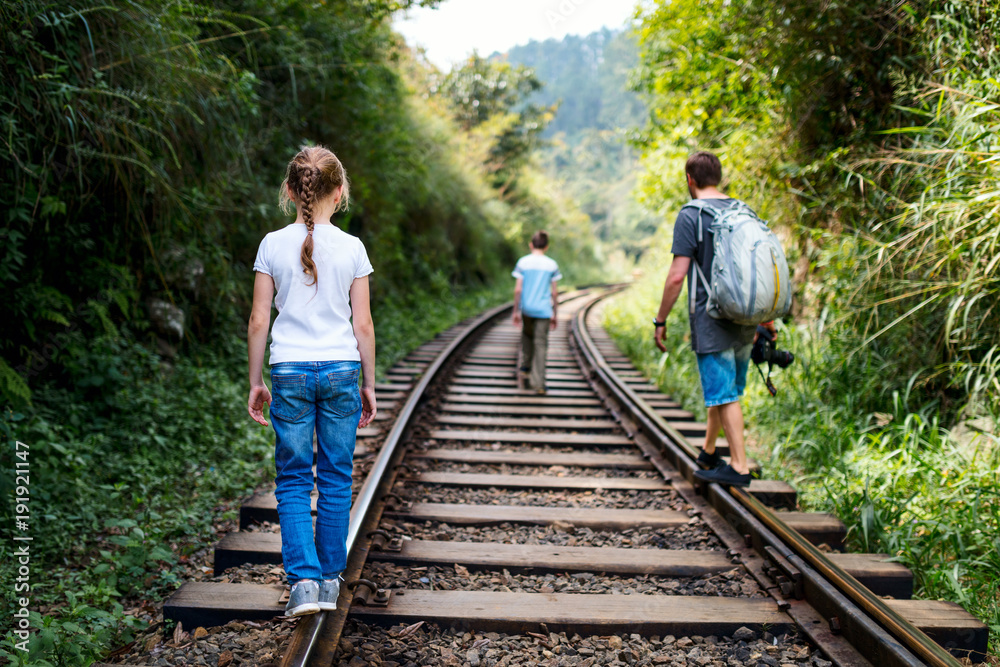 Family walking along train tracks
