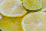 Lemon and lime slices close-up. Citrus on plates. Yellow with green.