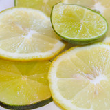 Lemon and lime slices close-up. Citrus on plates. Yellow with green.
