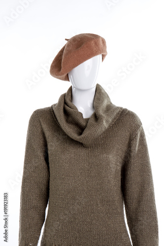 French beret and turtleneck sweater for women. Female mannequin dressed in beret and knitted pullover, white background.