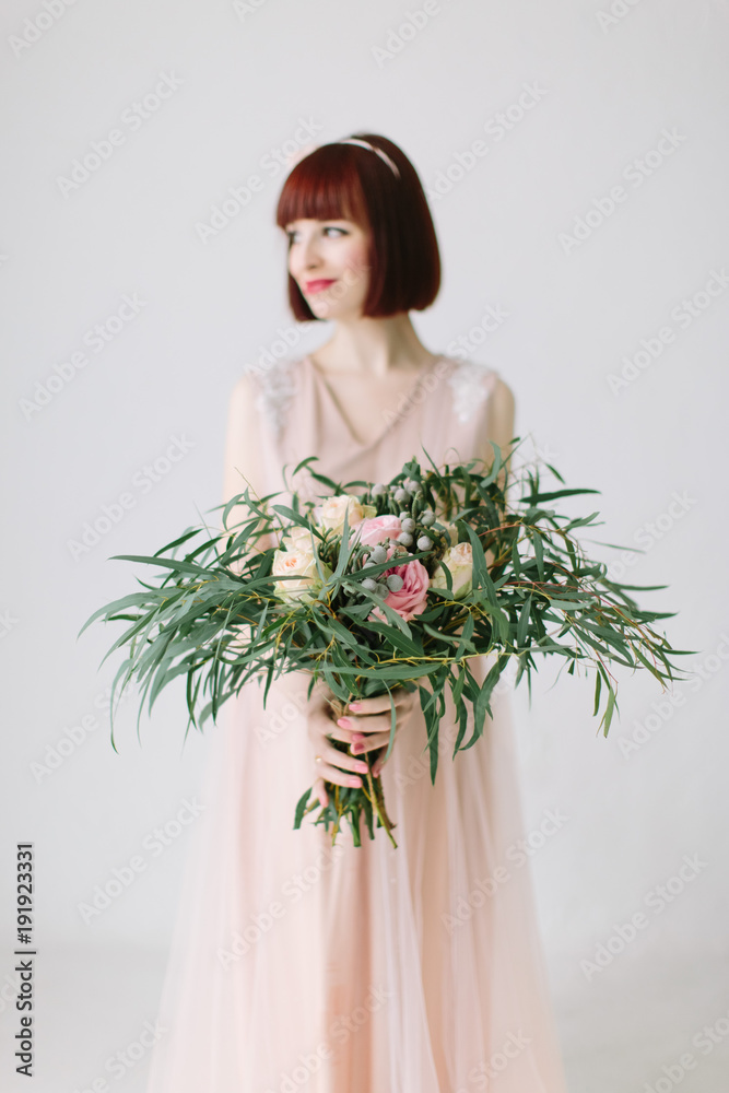 Pregnant girl is standing with large bouquet of flowers Pregnant girl is standing with large bouquet of flowers