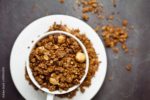 Granola in a white Cup on a black background. The concept of a healthy diet, weight loss, diet
