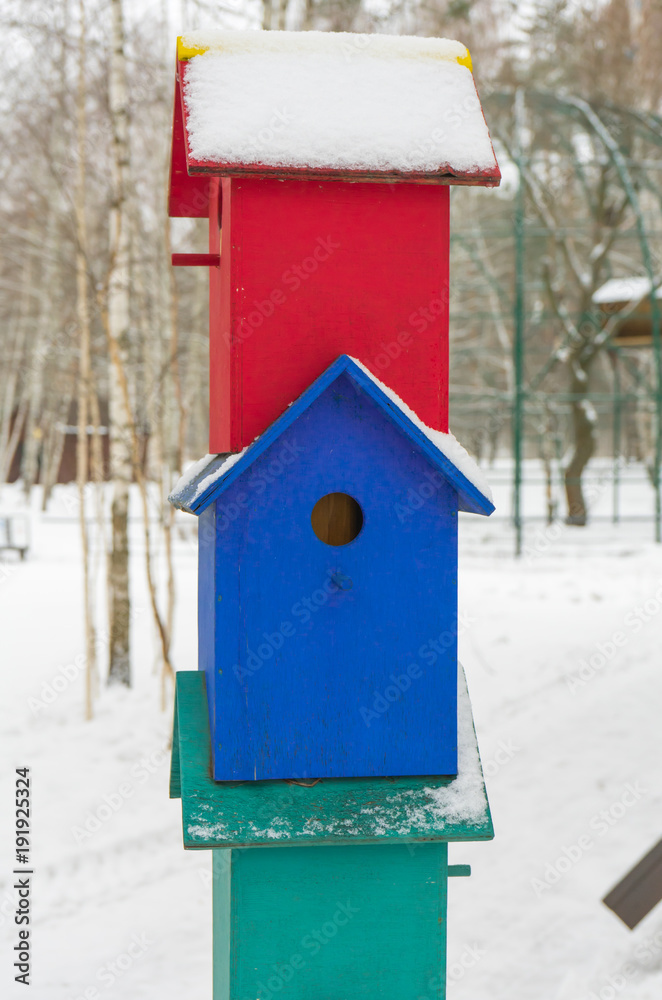 Colorful birdhouses for the birds in snow.