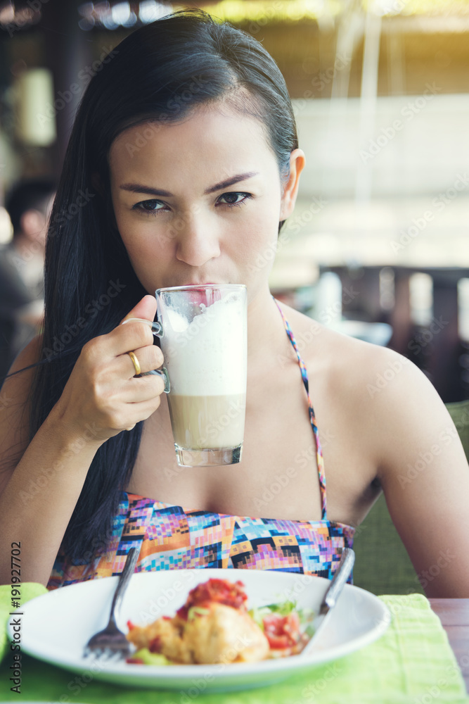 Beautiful women black hair having breakfast and drink coffee Beautiful women black hair having breakfast and drink coffee