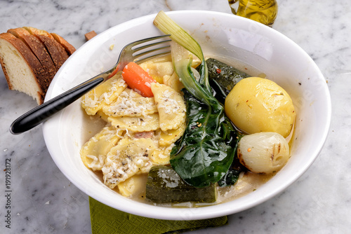 Delicious vegetable and vegetable soup with pasta agnolotti photo