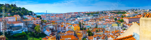 Summertime sunshine day cityscape panoramic view of town, Sao Jorge Castle, and all historic old centre in Lisbon, Portugal.