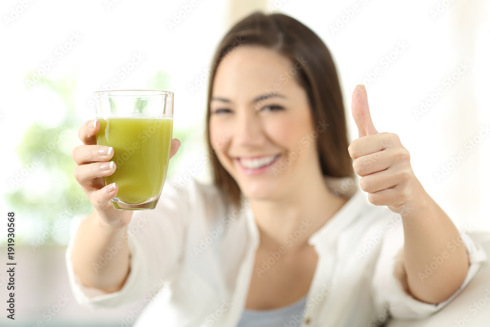 Proud woman showing a vegetable juice Proud woman showing a vegetable juice