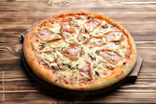 Hot big pizza with ham and mushrooms melting cheese bacon tomatoes