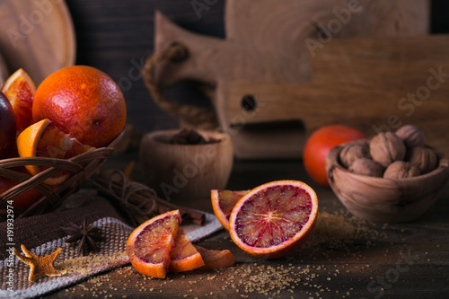 Fototapeta Naklejka Na Ścianę i Meble -  Fresh red orange fruit, anise, cinnamon and walnuts